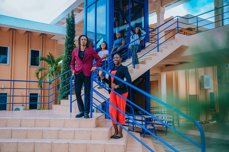 Young Professional Students standing at the stairs of the MSBM Building